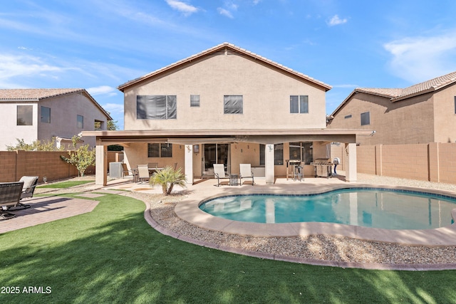 view of swimming pool with a yard and a patio