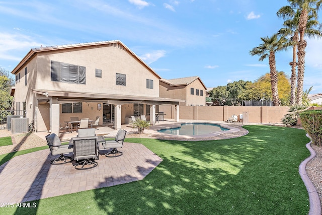 rear view of house with a fenced in pool, a patio, central AC unit, and a lawn