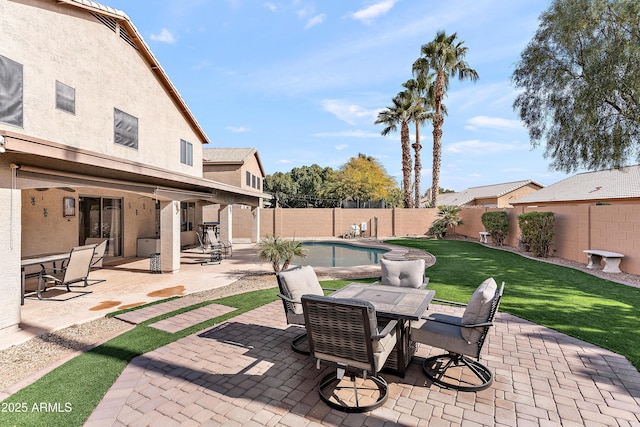 view of patio / terrace with a fenced in pool