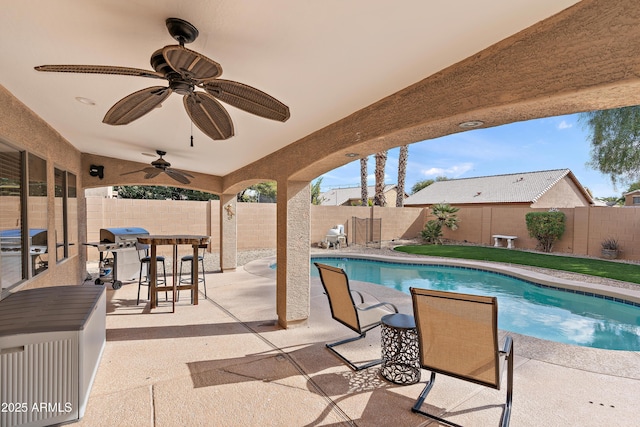 view of swimming pool with ceiling fan, a grill, and a patio