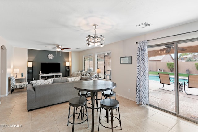 living room featuring light tile patterned flooring, a wealth of natural light, and ceiling fan