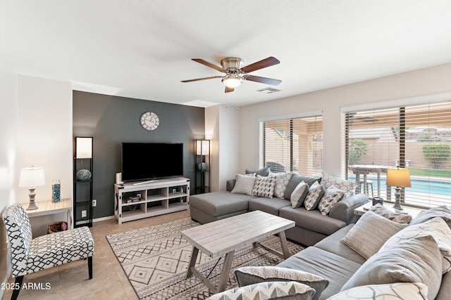 living room featuring ceiling fan and light tile patterned flooring