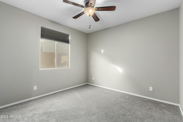 empty room with ceiling fan and carpet floors