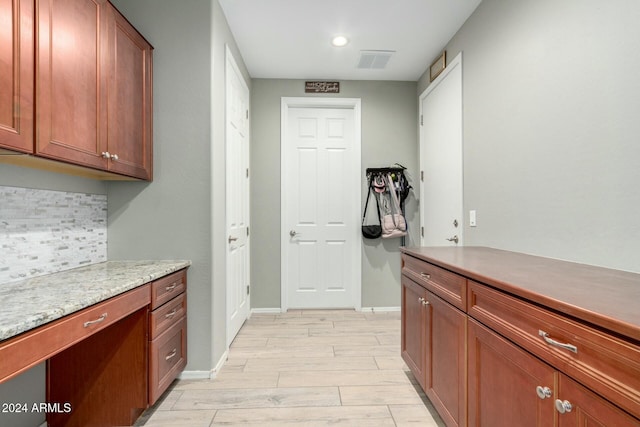 kitchen with backsplash and light hardwood / wood-style flooring