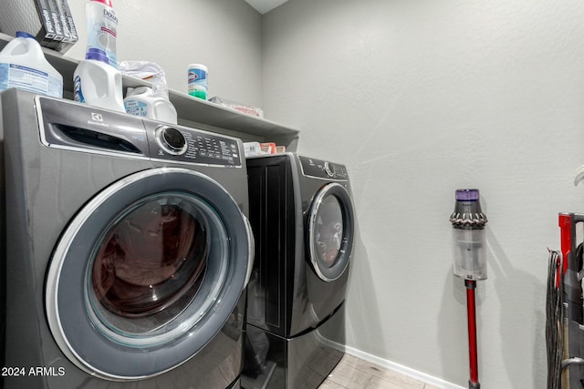 washroom with separate washer and dryer and light wood-type flooring