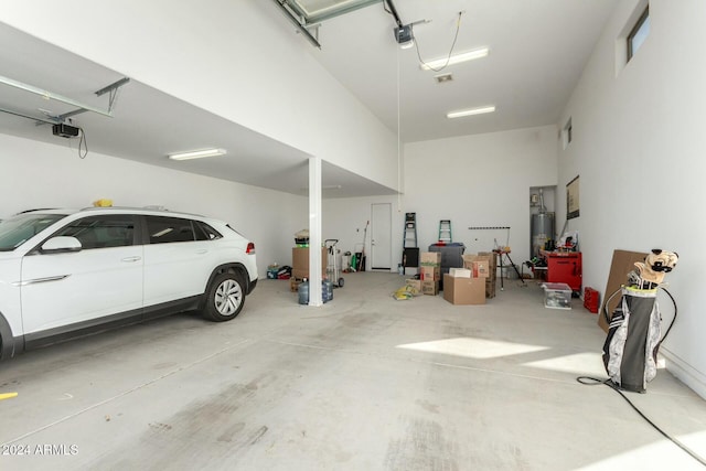 garage with a garage door opener and water heater