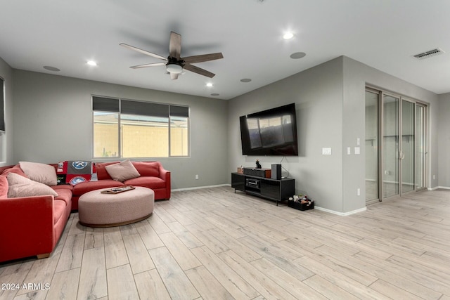 living room featuring ceiling fan and light wood-type flooring