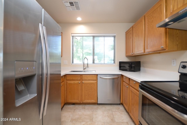 kitchen with ventilation hood, light tile patterned floors, sink, and appliances with stainless steel finishes