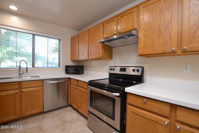 kitchen featuring light tile patterned floors, sink, and appliances with stainless steel finishes