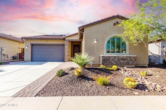 13448 W Miner Trl, Peoria, AZ 85383 - mediterranean / spanish home with stucco siding, a garage, concrete driveway, roof mounted solar panels, and a tile roof