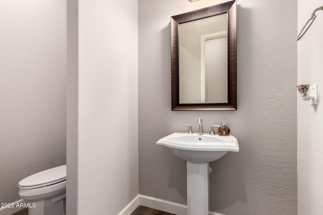 13448 W Miner Trl, Peoria, AZ 85383 - half bath featuring toilet, wood finished floors, and baseboards