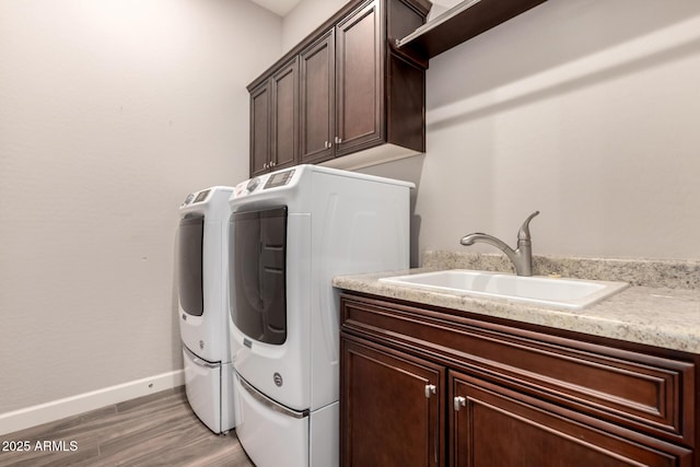 13448 W Miner Trl, Peoria, AZ 85383 - washroom with washing machine and dryer, cabinet space, baseboards, and light wood finished floors