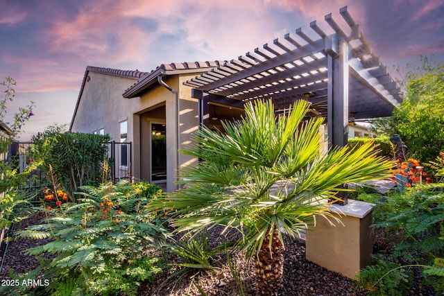 13448 W Miner Trl, Peoria, AZ 85383 - view of home's exterior with a pergola, stucco siding, and a tile roof