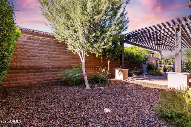 13448 W Miner Trl, Peoria, AZ 85383 - yard at dusk featuring a pergola, a patio area, and a fenced backyard