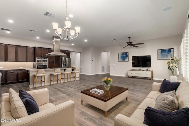13448 W Miner Trl, Peoria, AZ 85383 - living area with a chandelier, dark wood-style flooring, ceiling fan, baseboards, and recessed lighting
