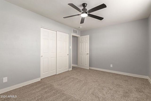 unfurnished bedroom featuring carpet flooring, ceiling fan, and a closet