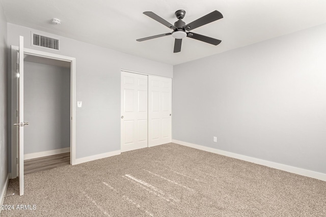 unfurnished bedroom with carpet floors, a closet, and ceiling fan