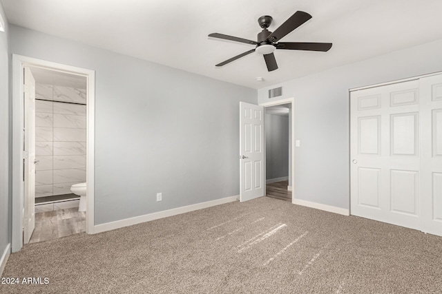 unfurnished bedroom with carpet flooring, ensuite bath, ceiling fan, and a closet