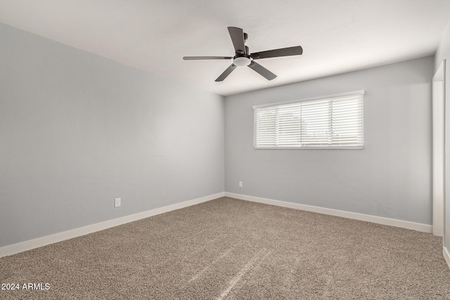 empty room featuring carpet flooring and ceiling fan