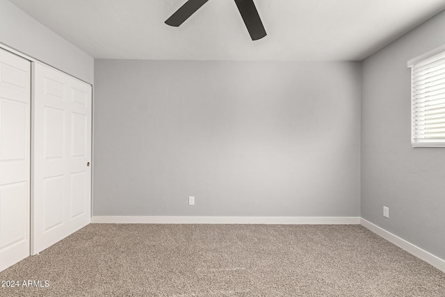 unfurnished bedroom with carpet flooring, ceiling fan, and a closet