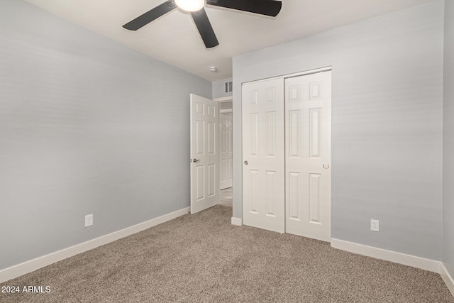 unfurnished bedroom featuring carpet flooring, a closet, and ceiling fan