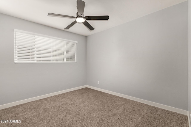 spare room featuring carpet and ceiling fan