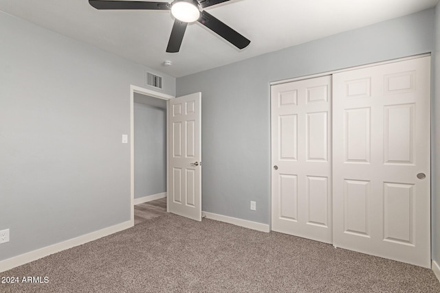 unfurnished bedroom with carpet flooring, ceiling fan, and a closet