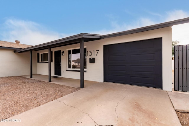 single story home with a porch and a garage