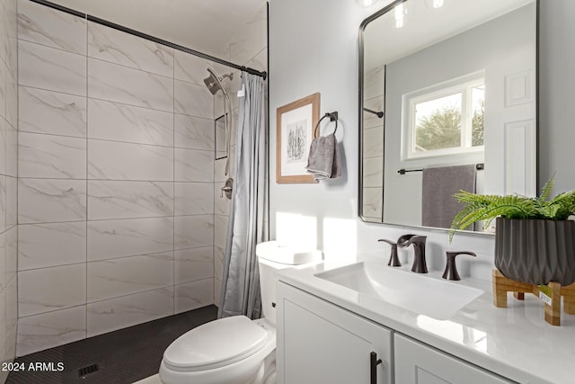 bathroom with a shower with shower curtain, vanity, and toilet