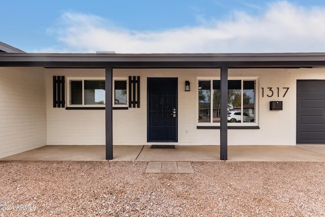 doorway to property featuring a garage