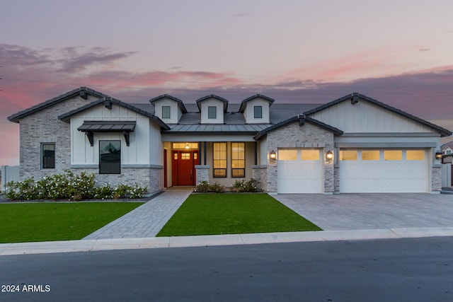 view of front facade with a yard and a garage