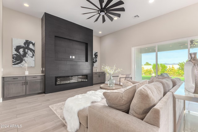 living room featuring a large fireplace and light hardwood / wood-style floors