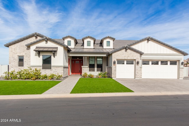 view of front of property featuring a porch, a garage, and a front yard