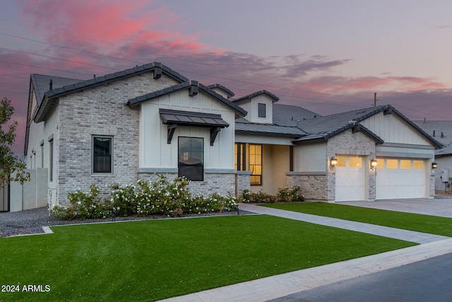 view of front of house featuring a garage and a lawn