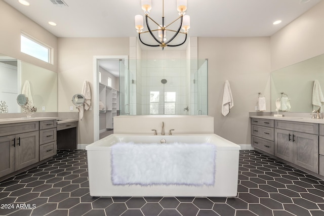 bathroom featuring vanity, a chandelier, and walk in shower