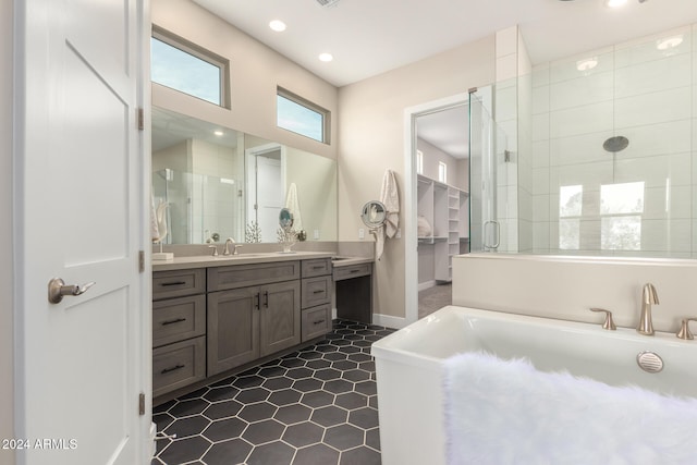 bathroom featuring tile patterned floors, vanity, and shower with separate bathtub