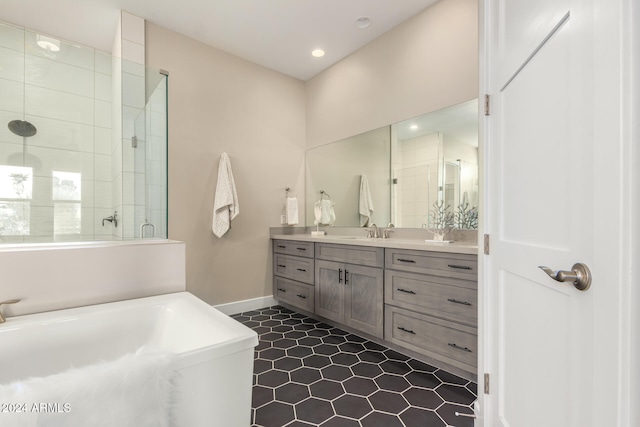 bathroom with tile patterned flooring, vanity, and walk in shower