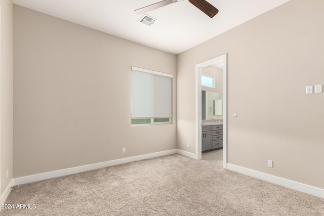 carpeted empty room featuring ceiling fan and sink