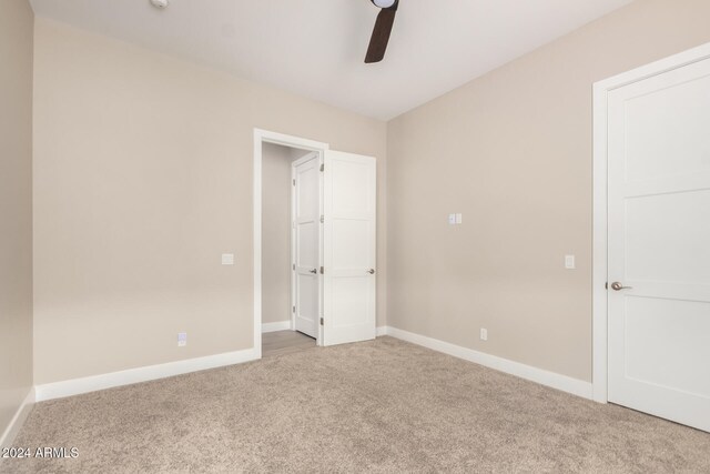 unfurnished bedroom featuring carpet flooring and ceiling fan