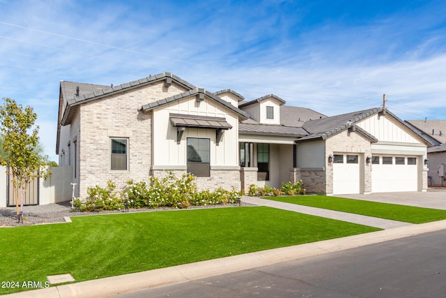 view of front of property with a front yard and a garage