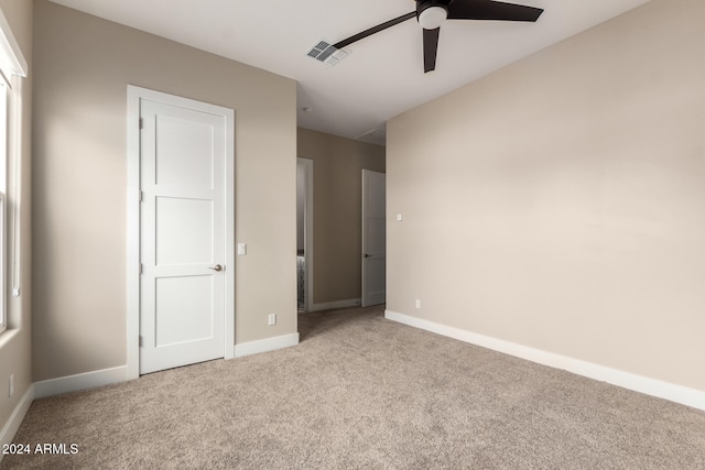 unfurnished bedroom with ceiling fan and light colored carpet