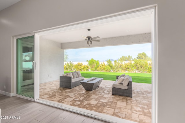 view of patio with ceiling fan and an outdoor living space