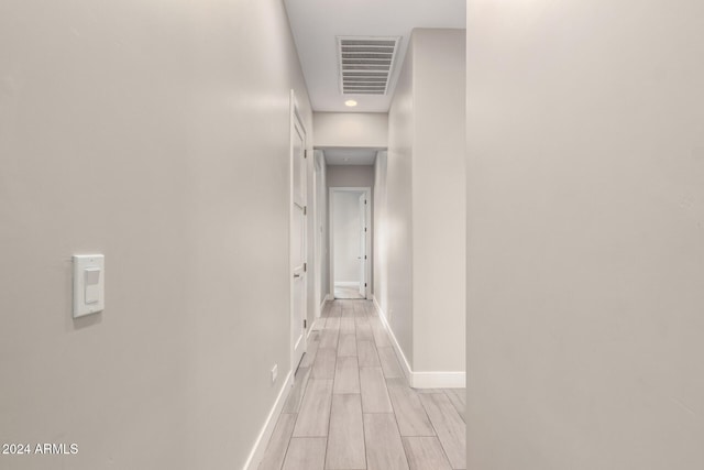 hallway with light hardwood / wood-style flooring