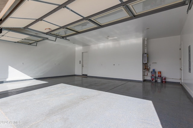 garage featuring electric panel and tankless water heater