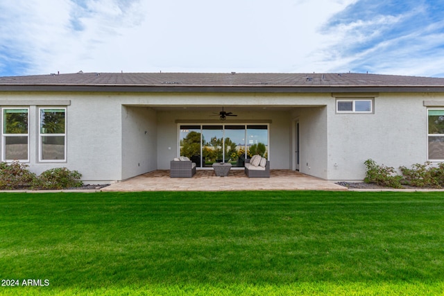 rear view of property with a lawn, ceiling fan, and a patio area