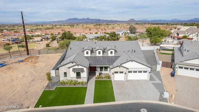 birds eye view of property with a mountain view