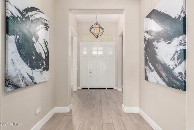 entryway with a chandelier and light hardwood / wood-style floors