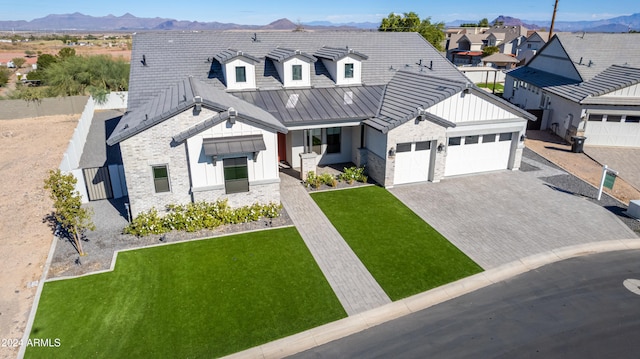 modern farmhouse with a mountain view, a garage, and a front lawn