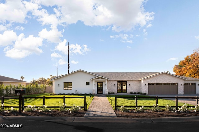 view of front facade with a garage and a front lawn