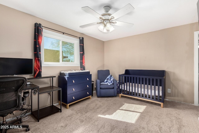 bedroom featuring light colored carpet and ceiling fan